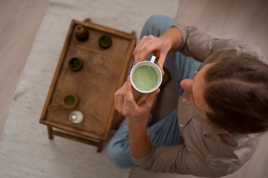 Top view of a man enjoying a cup of matcha tea, a healthy corporate Diwali gift idea